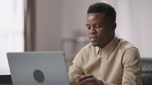 Young Adult on Video Call Using Laptop Indoors