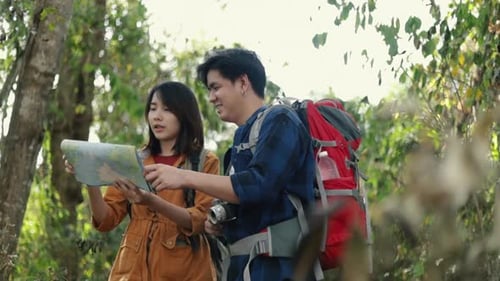 Young Couple Hiking and Navigating with a Map