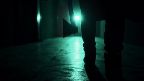 Figure Walks Dark Corridor With Axe