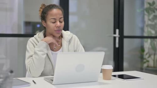 African Woman Talking on Video Call on Laptop in Office