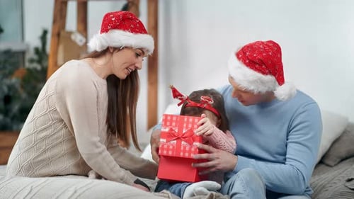 Family Celebrates Christmas, Opening Gifts