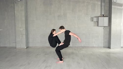 Couple of Professional Dancers Training in Modern Studio