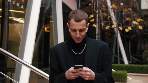 Caucasian Man Using Phone and Receiving Good News at Street. Business Man Using Phone Outdoor.