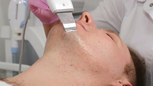 Man Receiving Ultrasound Facial Treatment at Clinic