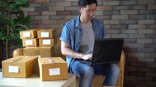 Young Adult Checking Orders at Home
