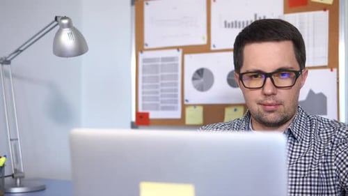 Close Up Shot of a Man's Face Who Working with Laptop in the Office