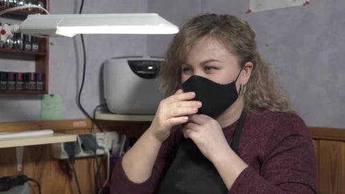 Woman Puts On Face Mask in Salon