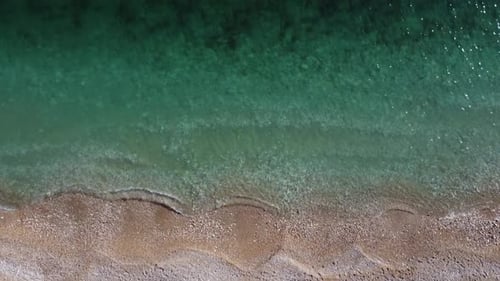 Aerial View From Above on Azure Sea and Pink Pebbles Beach