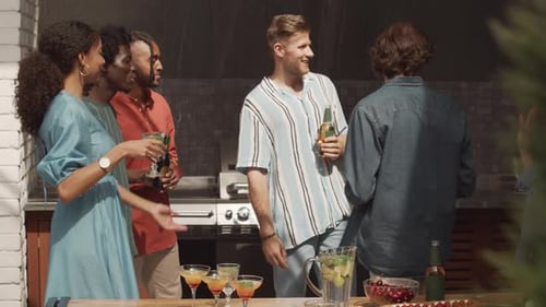 Multiethnic Friends Clinking Glasses at Summer Party on Terrace