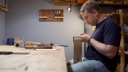 The Man with the Leather Needle To Sew in the Workshop. He Makes a Purse for Individual Design