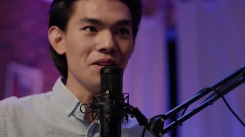 Asian Man Talking to Channel Audience on Podcast Show