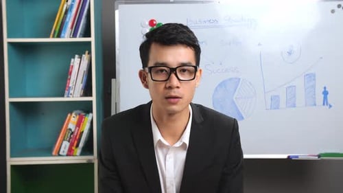 Business Professional Giving Presentation in Office Setting