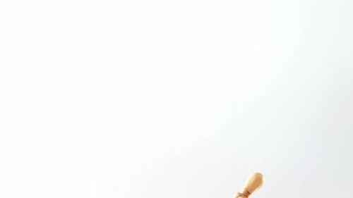 Wooden Mannequin Bent Over on White Background