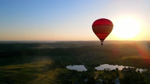 Hot Air Balloon Over Rural Landscape at Sunrise