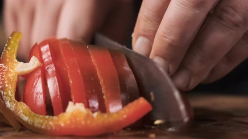 Extreme Close Up Chef in Restaurant Kitchen Cut Red Pepper with Sharp Shiny Knife