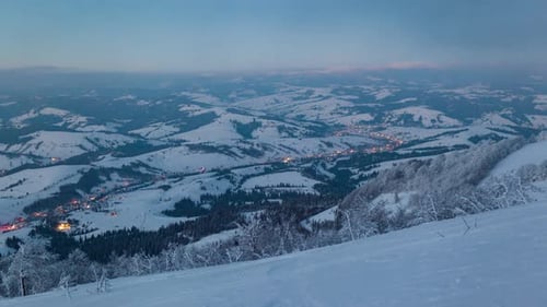 Time Lapse Video with Blue Sky Fog and Snow of a Starry Sky Over Snowy Ski Resort in the Mountains