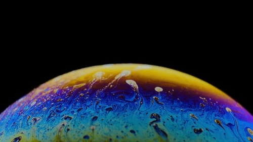 Multicolored Rainbow Colors of a Single Soap Bubble That Looks Like a Fantasy Planet Isolated