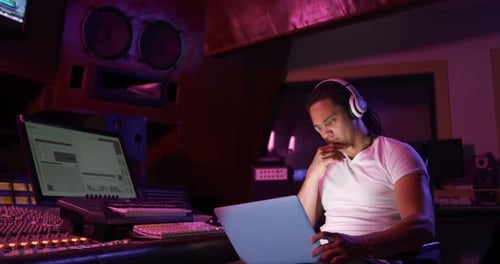 Male sound engineer using a laptop