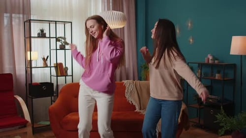 Happy Two Teenage Girls Siblings or Bloggers Couple Dancing at Home Having Fun Enjoying Trendy Dance