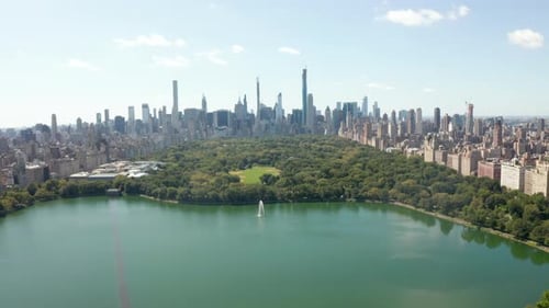 Beautiful Central Park View with Lake and Manhattan Skyline in Background at Sunny Summer