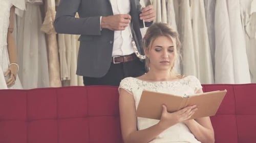Man Giving Bride Pearl Necklace in Bridal Shop