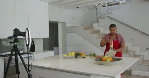 Woman Making Smoothie While Recording Video