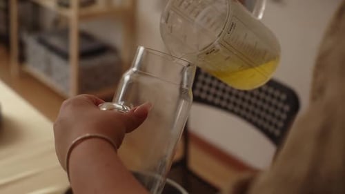 Pouring Liquid Ingredients Into Glass Jug