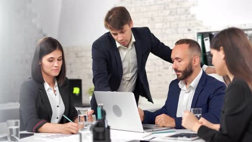 Business Team Collaborating on Project in Modern Office