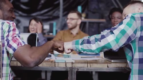 Team Fist Bump in Modern Office Workplace