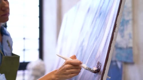 Woman Painting on Canvas in Studio
