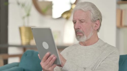 Old Man Using Digital Tablet