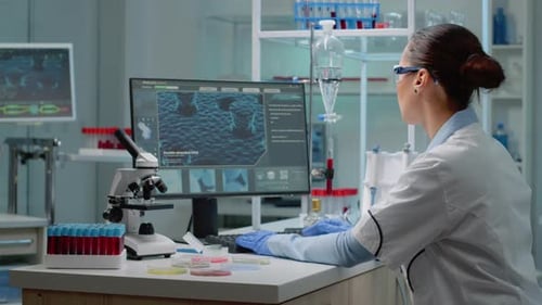 Female Scientist Working in Bright Modern Laboratory