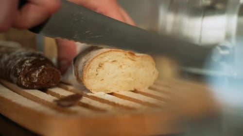 Slicing fresh bread with a knife on a cutting board