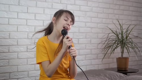 Enthusiastic Child Singing into Microphone in Bedroom