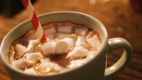 Close Up of Hot Chocolate with Marshmallows and Straw