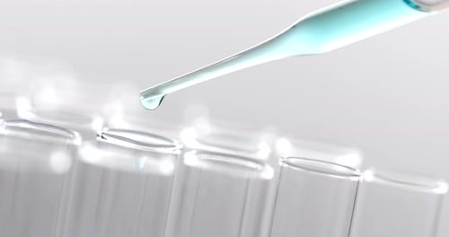 Pipette Adding Liquid to Test Tube Rack Close Up