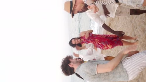 Vertical Video of a Group of Multiethnic Young People Dancing on the Beach