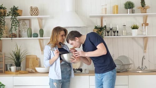 Young Couple Cooking Together in Kitchen