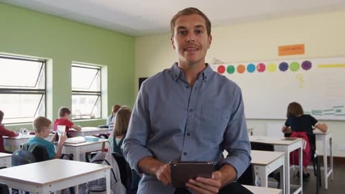 Smiling Teacher with Tablet in Modern Classroom Setting