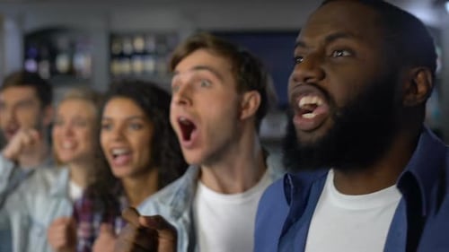 Excited Sports Fans Cheering in a Bar