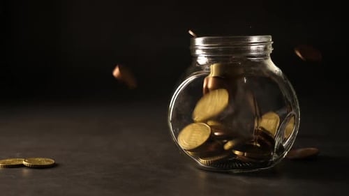 Coins Falling into Jar