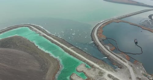Aerial View. Drone Flying Forward Over a Polluted Sea with Destroyed Ecosystem. Slag Dump Poisoning