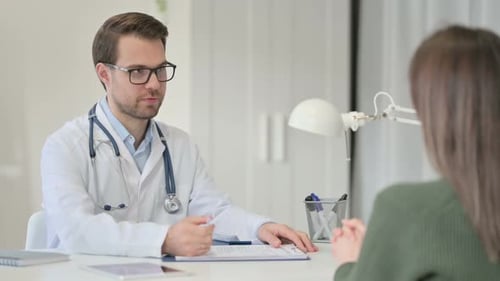 Doctor Consulting Patient in Bright Medical Office