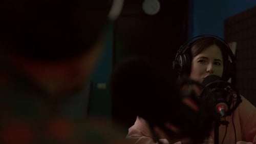 Woman Speaks Into Microphone in Studio