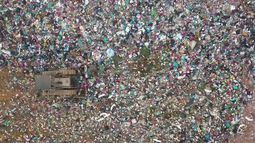 Aerial view dozer used for waste handling at rubbish dump landfill