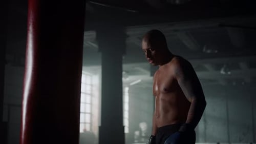 Athletic Guy Punching Bag in Sport Club