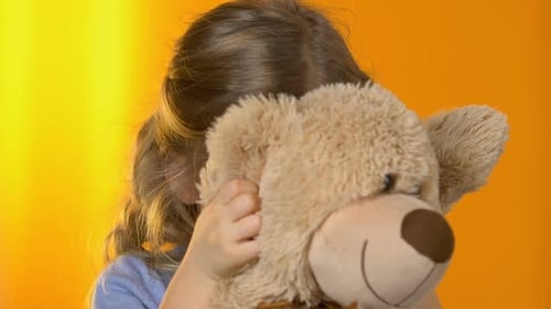 Smiling Girl Holding Teddy Bear Friend Close Up