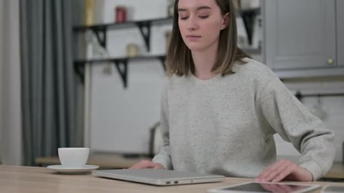 Woman Opens Laptop and Begins Work at Table