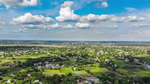 Hyperlapse of Village and Small Houses with Moving Clouds in Sky From a Flying Drone