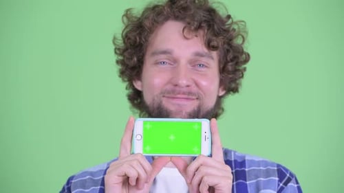 Man Holding Phone with Green Screen Smiling